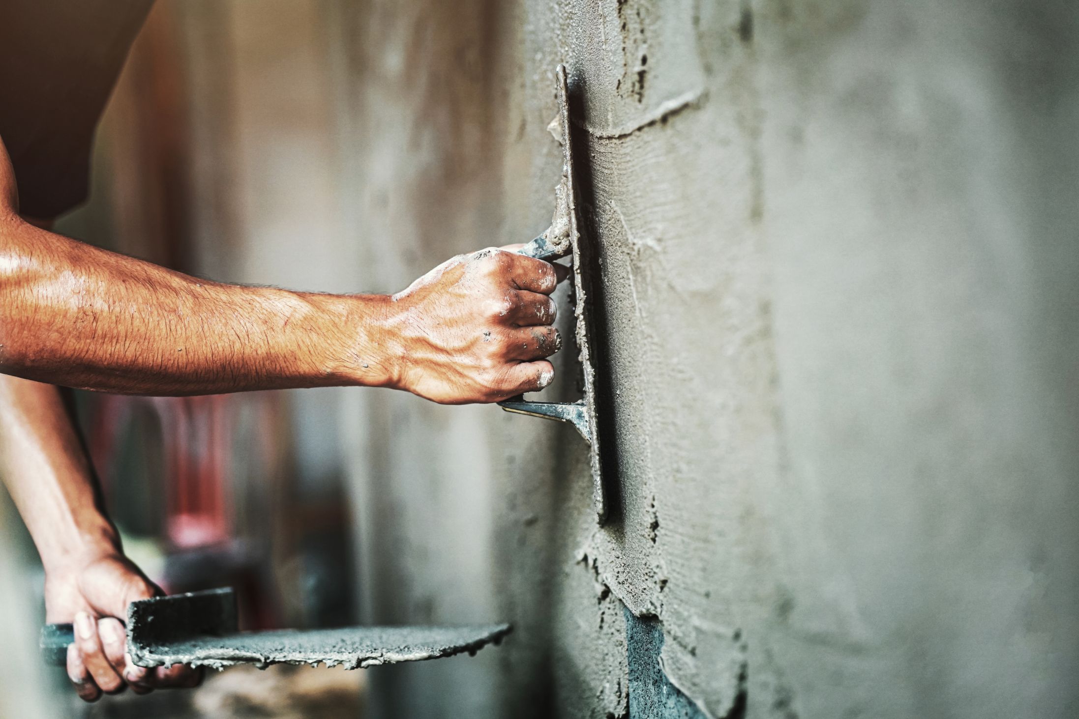 closeup-hand-worker-plastering-cement-wall-building-house